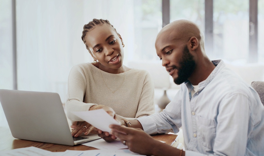 black couple going over home purchase materials