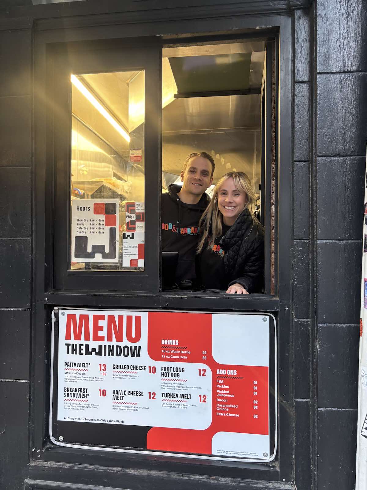Oskar and Katrina Duva in the window at The Window next to South Street dive bar Bob & Barbara's
