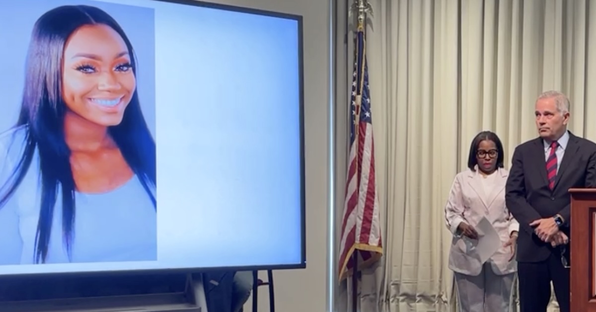 Larry Krasner stands near an image of Kada Scott during a press conference in Philadelphia