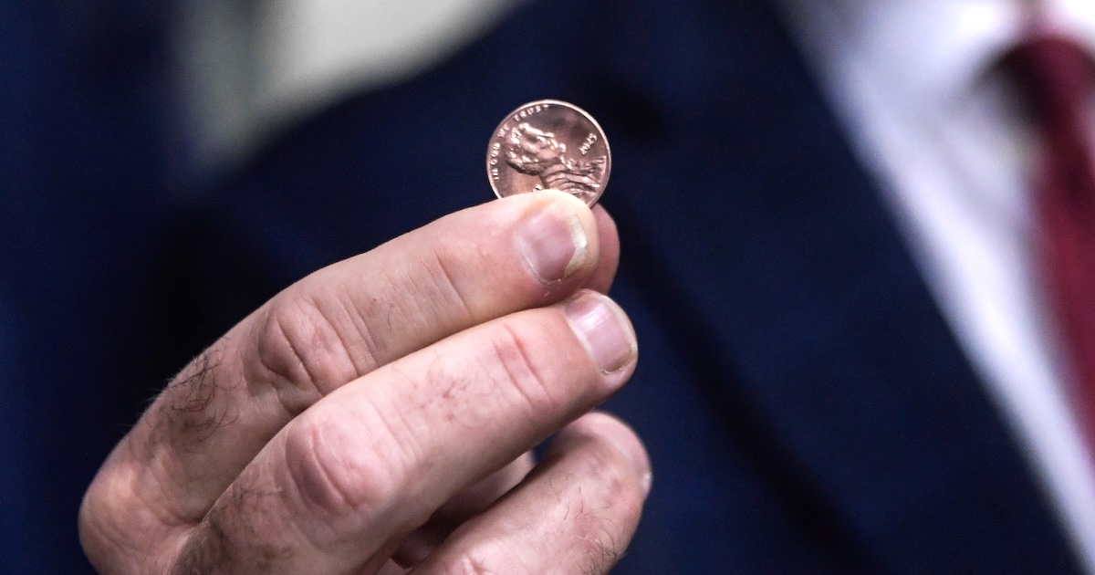 Treasurer of the United States Brandon Beach holds the last penny stamped at the US Mint on November 12, 2025 in Philadelphia, Pennsylvania. Beach pressed the final pennies at an event held at the facility. The pennies pressed bear a special 'Omega' and will not be put in circulation, but will be auctioned off. (Photo by Matthew Hatcher/Getty Images)